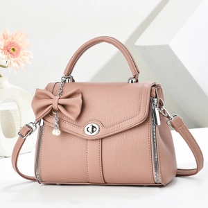 Pink lychee texture leather crossbody bag with elegant bow and pearl charm ornament