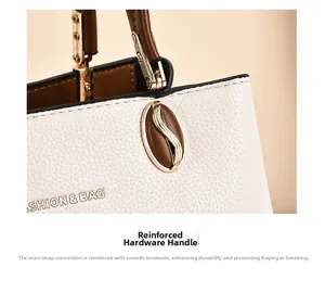 Close-up of reinforced gold metal hardware connecting the brown handle to the beige handbag