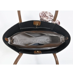 Internal view of a leather tote bag showing herringbone lining and zippered compartments