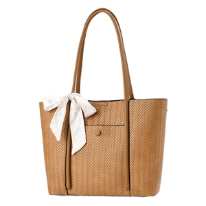 Brown woven texture tote bag with leather straps and decorative bow scarf on white background