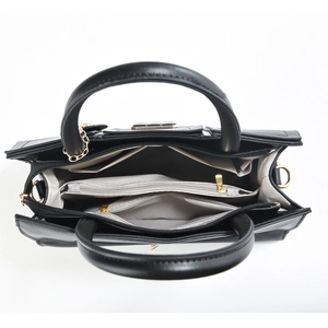 Top view of black mini crossbody bag showing multiple interior zipper compartments and hardware