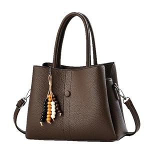 Brown litchi grain leather handbag with wide shoulder strap and wooden bead charm