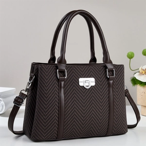 Elegant dark brown handbag with herringbone texture and silver lock from a 45-degree angle
