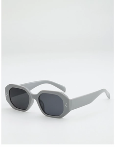 Détail macro de lunettes de soleil hexagonales grises avec rivets triples sur monture épaisse