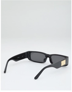 Detail view of black square sunglasses featuring gold glitter metal accents and dark lenses