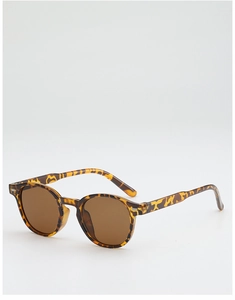 Vue détaillée de lunettes de soleil vintage écaillées avec verres bruns et monture ovale
