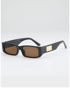 Detail view of rectangular sunglasses with black frame and gold metal side accents