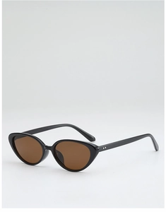 Close-up of retro cat-eye sunglasses with black frame and decorative metal rivets