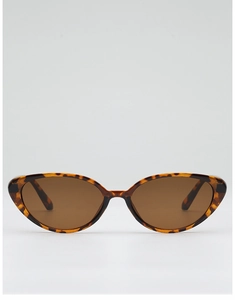 Frontal detail of tortoiseshell cat-eye sunglasses with brown lenses and retro studs