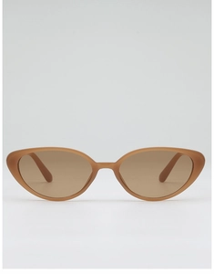 Close-up of translucent amber cat eye sunglasses with stylish rice nail metal accents