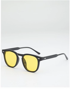 Detail of trendy round black frame sunglasses with yellow lenses and metal accents