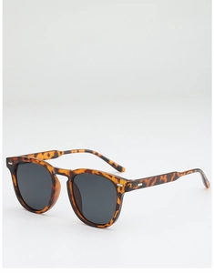 Detail of tortoise shell sunglasses frame with dark lenses and silver hinge accents