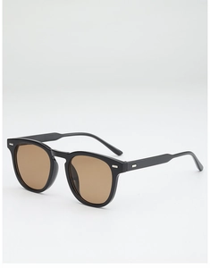 Detail of round sunglasses with silver rivets, black frames and brown lenses