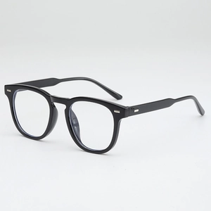 Close-up of black full-rim glasses with rectangular silver metal accents on the frame