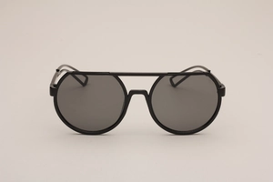 Close-up of black round sunglasses for kids with double bridge and hollowed temples