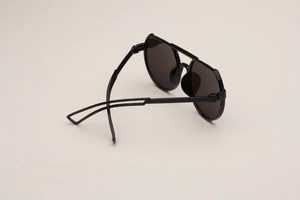 Detail view of black geometric sunglasses for kids with durable frame and dark lenses