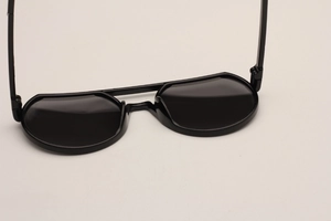 Close-up of sleek black children sunglasses with glossy finish and dark lenses