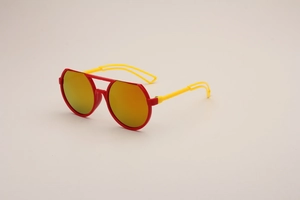 Detail view of stylish kids sunglasses featuring red frames and yellow hollowed temples