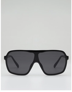 Close-up of classic black oversized aviator sunglasses with integrated dark lenses