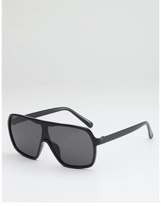 Detail view of the sleek oversized black frame and dark tinted lenses of these sunglasses