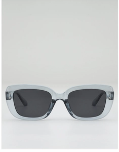 Macro shot of grey transparent square sunglasses with black lenses and metal temple hinges