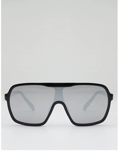 Macro shot of oversized wrap-around sunglasses with glossy black frame and grey lens