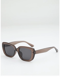 Detail of square tea-brown sunglasses featuring silver rivets and model CV2633 engraving