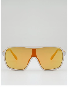 Close-up of white oversized sunglasses with a single orange lens and bold retro frame