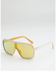 Detail view of large frame sunglasses featuring yellow mirrored lenses and white accents