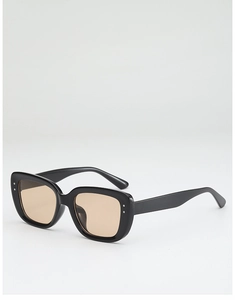 Close-up of square sunglasses with silver metal rivets and amber tinted lenses