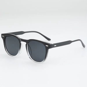 Classic round gradient black sunglasses with silver rivet accents and dark lenses