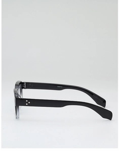 Detail of black glasses frame with three metal studs and engraved model number CA2900