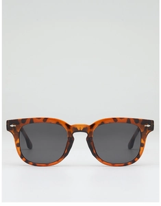 Detailed view of tortoiseshell square sunglasses with dark grey lenses and metal rivets