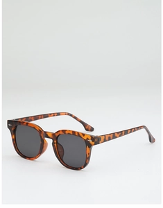 Detail shot of vintage tortoise shell frame sunglasses with silver metal accents and gray lenses