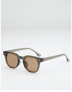 Close-up of translucent grey square frame sunglasses with brown lenses and metal accents