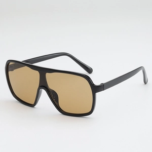 Oversized wrap-around sunglasses with black glossy frames and yellow tinted lenses