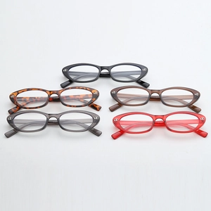 Detailed stack of vintage cat-eye glasses frames in multiple colors with silver accents