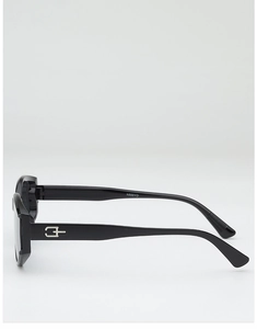 Close-up of black cat-eye sunglasses with thick temples and silver geometric logo detail