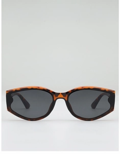 Detail of trendy tortoiseshell cat-eye sunglasses with dark grey lenses and retro pattern
