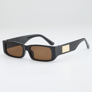 Retro rectangle sunglasses with black thick frames and amber lenses with gold metal detail