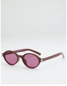 Macro view of burgundy oval frames with purple lenses and silver hinge details