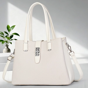 Detail of white soft leather and woven fabric bucket bag with metallic buckle closure