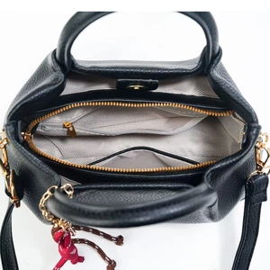Detailed top-down view of black pebbled leather bag interior with grey chevron lining