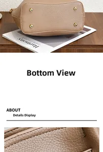 Detail of brown lychee grain leather bag base featuring four golden protective metal studs
