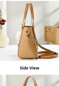Detail view of woven shoulder bag featuring golden hardware and plush pendant charm