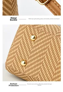 Close-up of golden metal clasp and protective bottom studs on contrast straw bucket bag