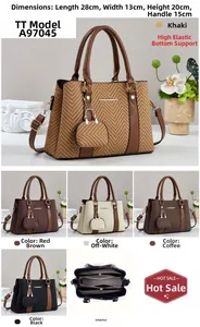 Detail view of woven texture tote bag with brown faux leather handles and interior compartments