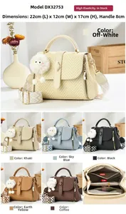 Detail of woven texture handbag with plush ball charm and colorful woven shoulder strap