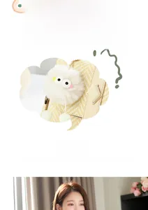 Detail of yellow woven texture handbag with a white plush pompom charm decoration
