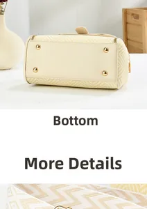 Detail view of woven handbag bottom with golden metal feet and matching strap texture